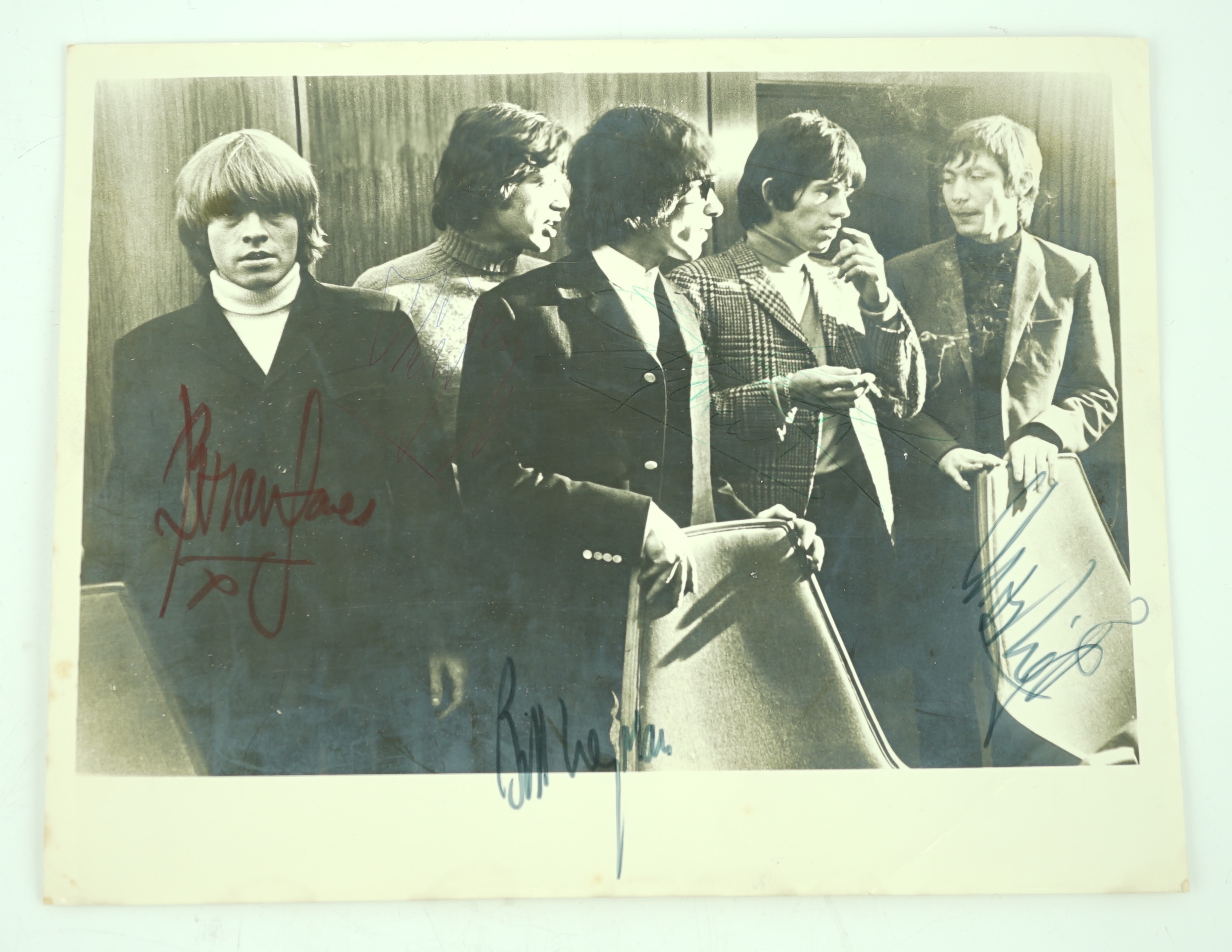 The Rolling Stones; a signed 1960s photograph including; Mick Jagger, Bill Wyman, Brian Jones, Keith Richards and Charlie Watts